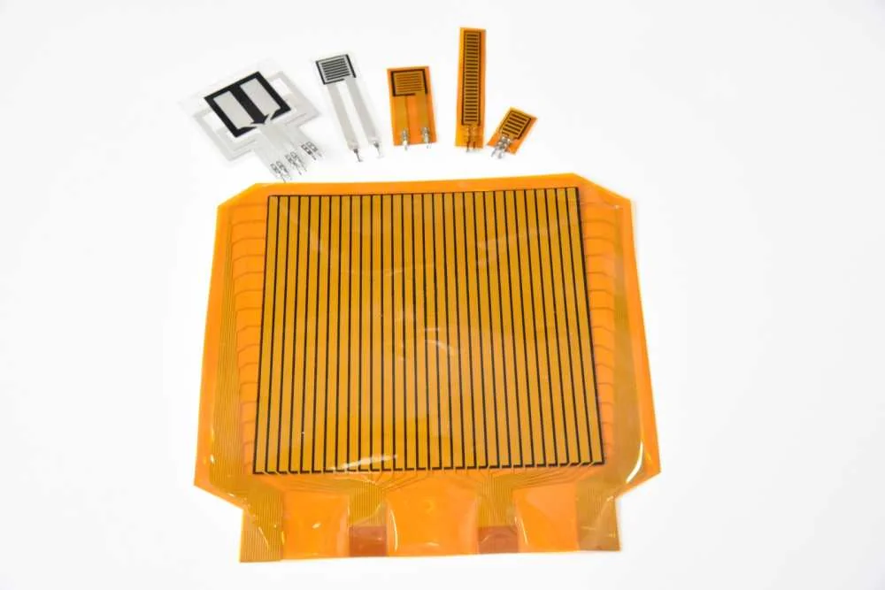 A thin tactile film sensor with a fine grid of sensing points and a flexible connector tail